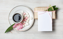 Eco Style Gift Box And Greeting Card With Pink Flowers And Coffee Cup A Over The Wooden Background. Top View, Flat Lay