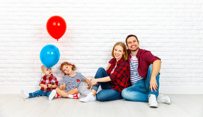 Happy family with ballons. mother, father, son, daughter on a white blank wall