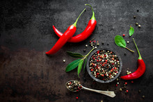 Red Hot Chili Pepeprs And Peppercorns On Black Metal Background, Top View