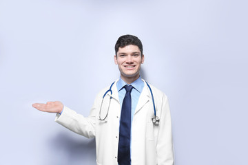 Wall Mural - Handsome young doctor on white background