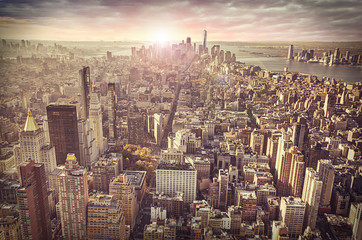 New York city skyline, sunrise in background.