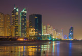 Fototapeta Londyn - Dubai - The nightly Marina towers from beach.