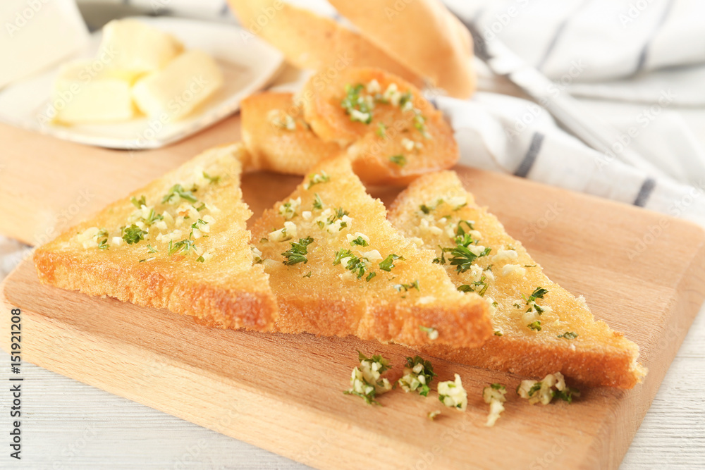 Garlic French bread slices on wooden board