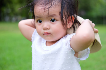 Cute Baby girl playing in the garden, close-up portrait, Portrait of Asian beautiful baby girl of 1 year and 3 months old.