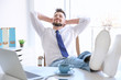© Africa Studio - Young businessman relaxing at workplace with his feet on desk
