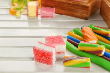 Sticker - Composition of tasty jelly candies on wooden background