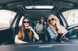 © F8  \ Suport Ukraine - three girls driving in a convertible car and having fun