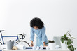 © wayhome.studio  - Dark-skinned young businesswoman working on weekend at home office on important project of her company, standing at white desk covered with papers and modern electronic gadgets, signing documents