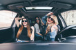 © F8  \ Suport Ukraine - three girls driving in a convertible car and having fun, listen music and dance