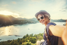 Young Woman Traveler In Sunglasses Makes Selfie With Sea View