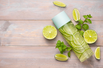 Wall Mural - Detox Infused Water with Lime and Mint in Sports Bottle, with slices of lime.