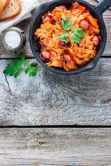 Wall Mural - Stewed cabbage with sausages, German cuisine, horizontal, copy space, top view