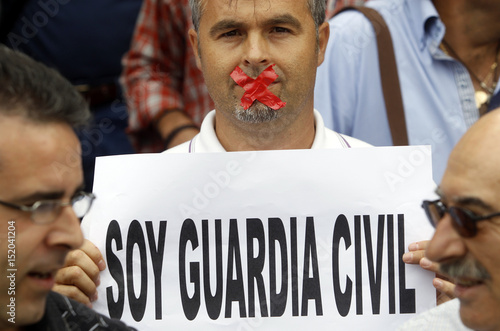 A Spanish Civil Guard Holds A Sign That Reads I M A Civil