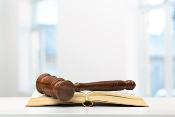 Wooden gavel and books on wooden table