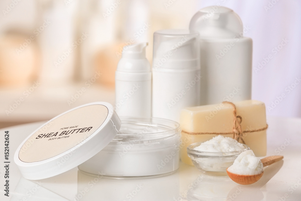 Composition of Shea butter with cosmetic products on table