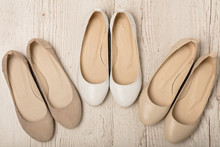Women Shoes (ballet Flats) White And Beige On A Light Wooden Background.