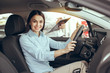 © Friends Stock - Young Woman in a Car Rental Service Test Drive Concept