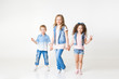 © Ксения Левашова - kids in jeans clothes posing in studio. Copy-space