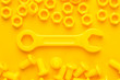 3d printed bolts nuts and wrench on yellow background