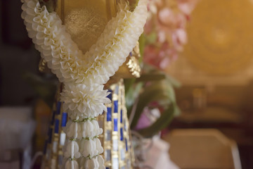 close up lovely flowers with Thai garland with blurry bokeh background