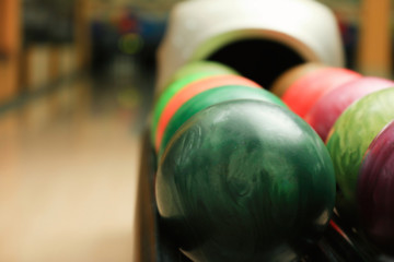  Colorful balls on rack in bowling club, closeup