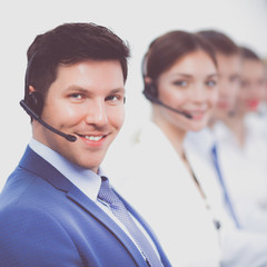 Wall Mural - Smiling positive young businesspeople and colleagues in a call center office