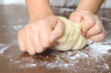 Bread cooking,kneading bread dough on wooden board by hand