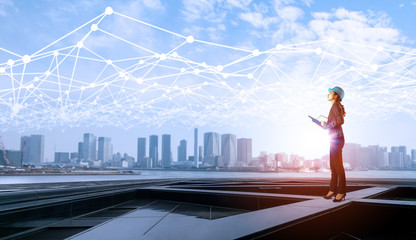Aufkleber - construction industry and Internet of Things concept. modern buildings. woman engineer. communication network.