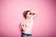 © bublik_polina - close-up portrait of young beautiful slim sexy young blonde woman in a retro pin-up style on pink background in studio wearing sunglasses smiling and posing