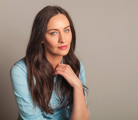 Poster - portrait of a beautiful woman in blue shirt sitting