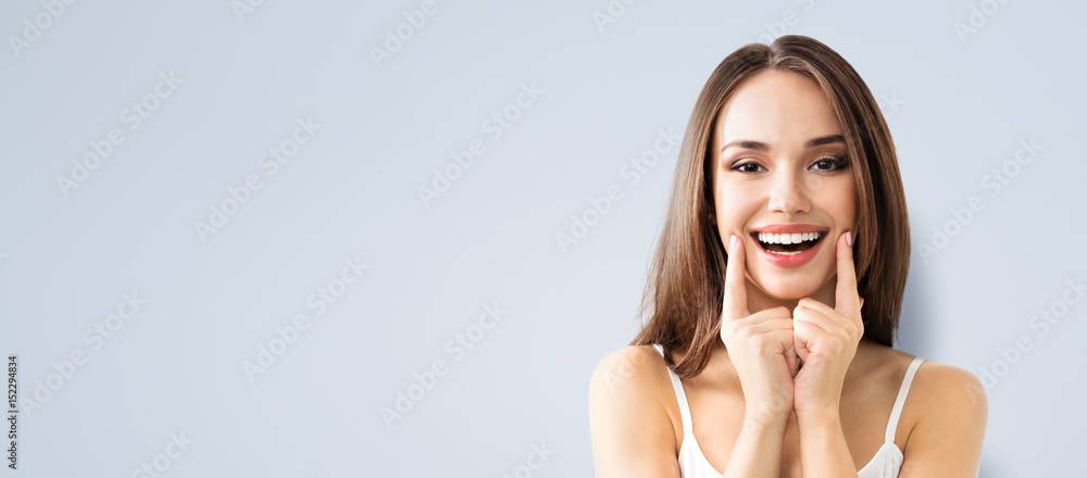 young woman showing smile - obrazy, fototapety, plakaty 