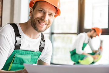 Hilarious smiling constructor in room