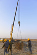 Hoisting steel bars in the construction site