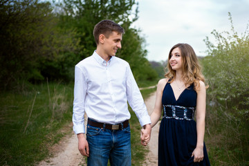 Couple in love walking in the woods holding hands 