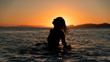 © CHAO - Silhouette girl in ocean during sunset