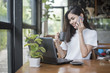 © tonefotografia - Beautiful business girl working with tablet , smartphone and drinking coffee in coffee shop