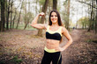 © F8  \ Suport Ukraine - Fitness girl in park showing biceps against park background
