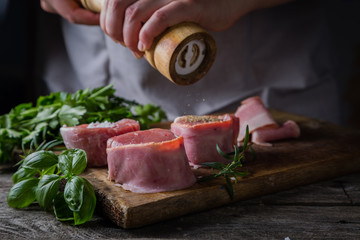 Wall Mural - Preparing filet mignon - hands seasoning the steak