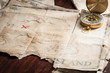 © Vladimir Borozenets - Top view to table with vintage map with abstract Island and nautical compass.