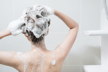 Woman In Shower Washing Hair With Shampoo