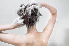 Woman In Shower Washing Hair With Shampoo