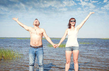 Happy young couple having fun in the water of sea