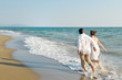 © tanialerro - Happy couple walking on the beach