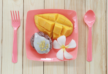 Wall Mural - mango and sticky rice on wood background.