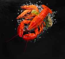 Top View Of Whole Red Lobster On Crushed Ice With Prawns And Oyster