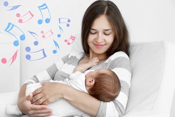 Poster - Portrait of pretty young woman holding sleeping baby at home