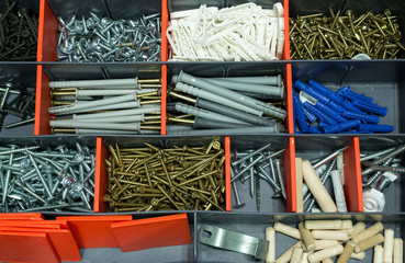 A box with screws, dyupels, fasteners.