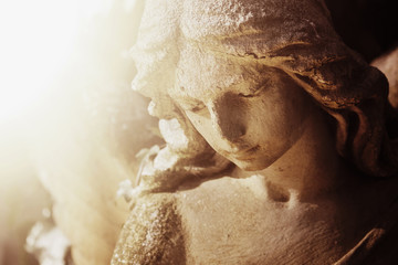 Fototapete - Vintage image of a sad angel on a cemetery against the background of leaves