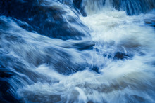 Powerful Currents Of River Water Converge In Violent Splashes.