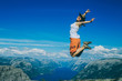 © Julia - The happy tourist is jumping. Norway. Background.